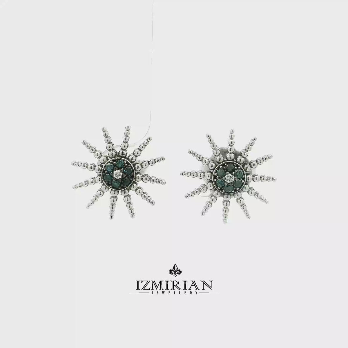 White gold sunburst stud with blue and white diamonds shown in motion