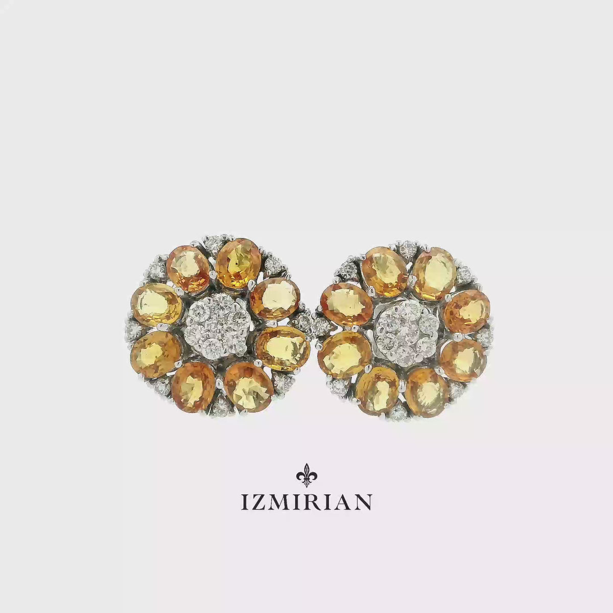 Citrine and diamond floral stud earrings in white gold shown in motion