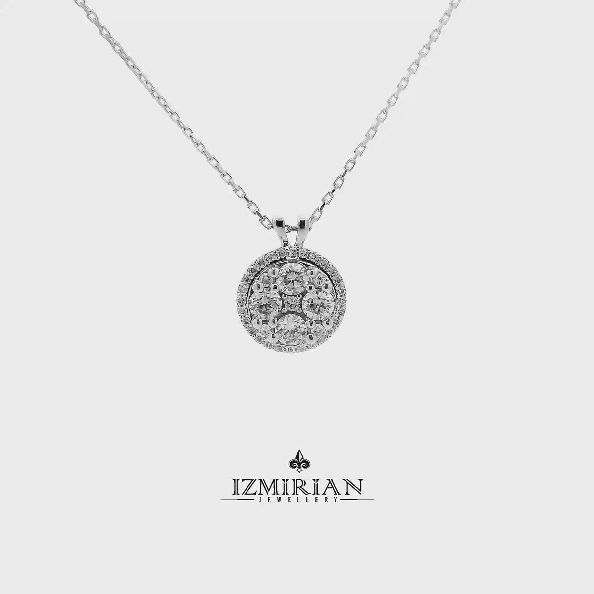 Diamond cluster circle pendant in white gold shown in motion