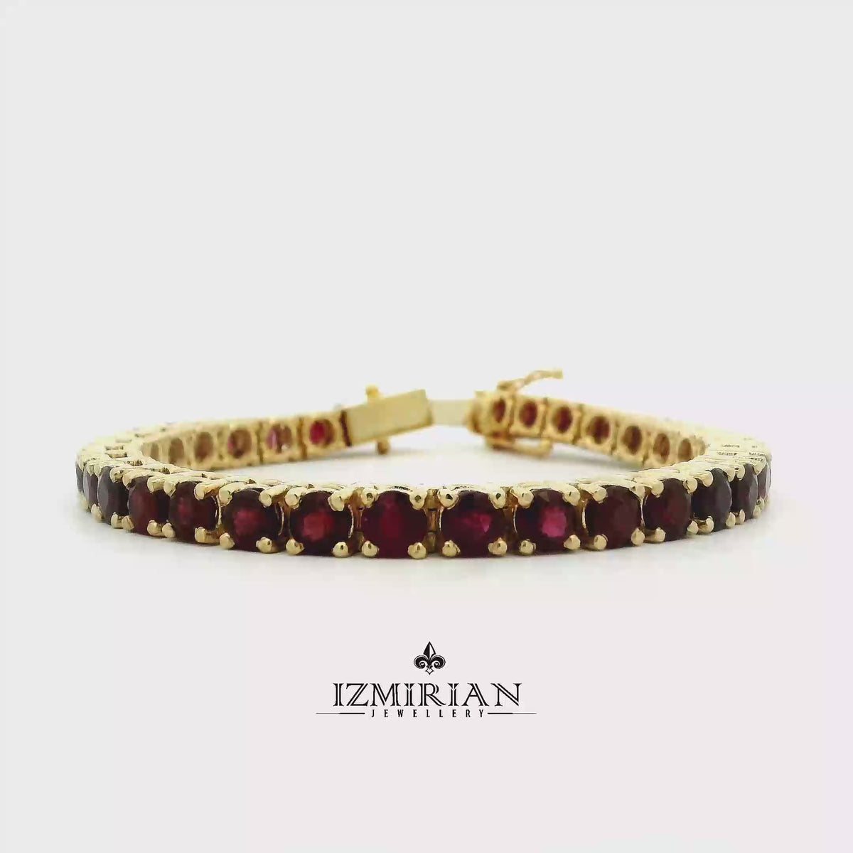 Ruby tennis bracelet in yellow gold shown in motion