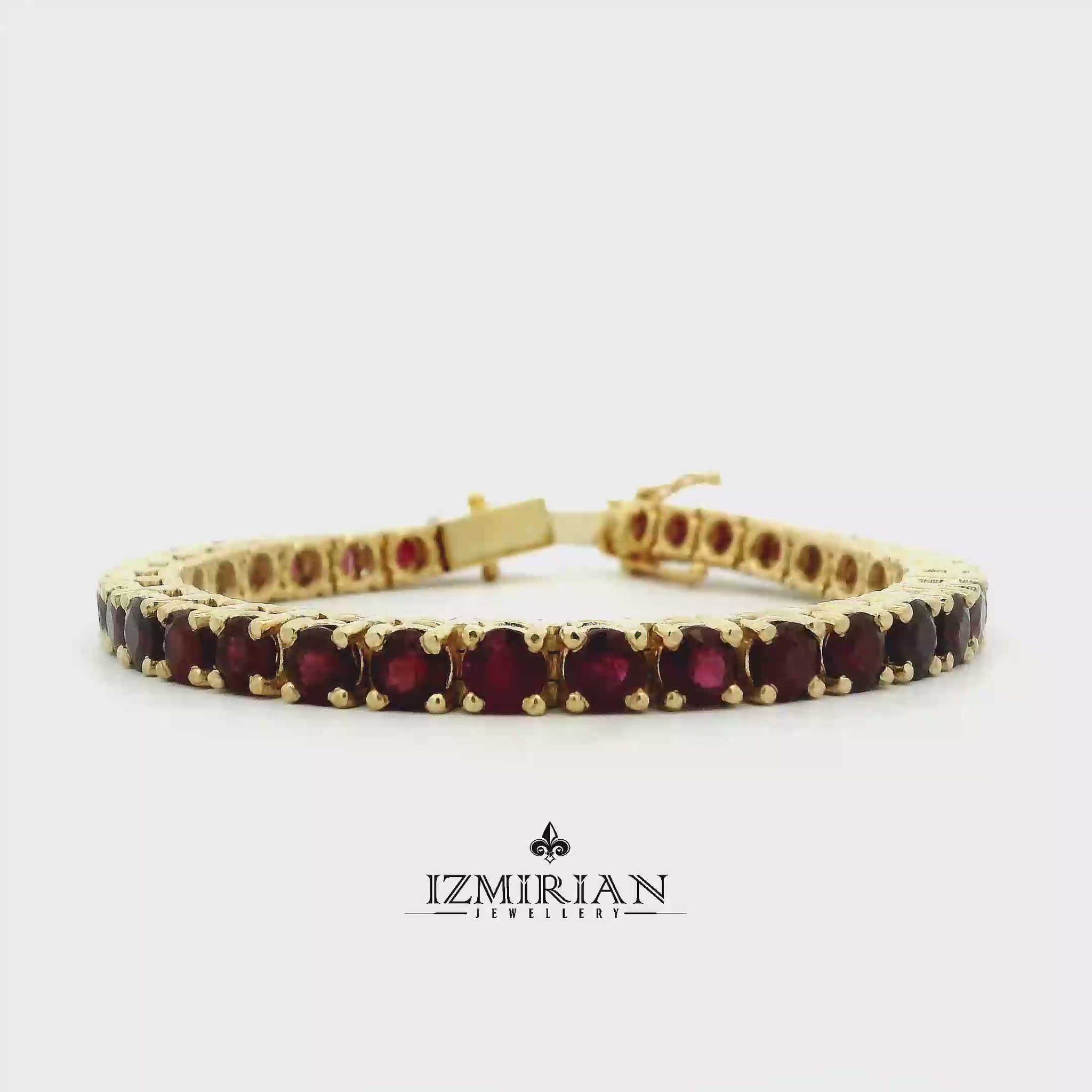 Ruby tennis bracelet in yellow gold shown in motion