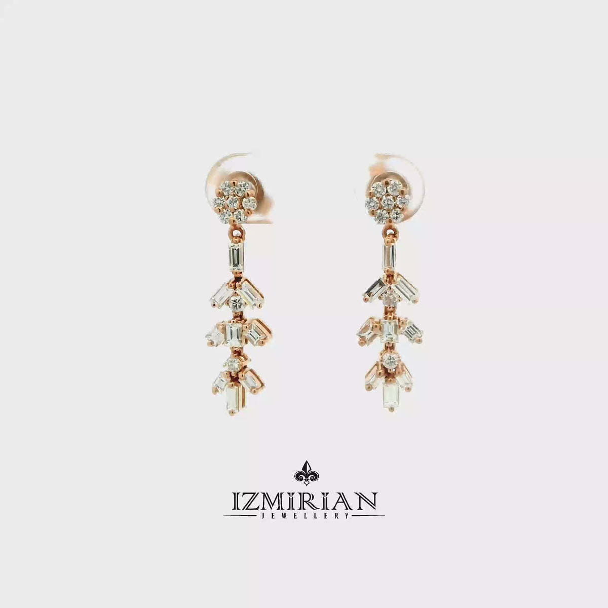 Baguette diamond drop earrings in rose gold shown in motion