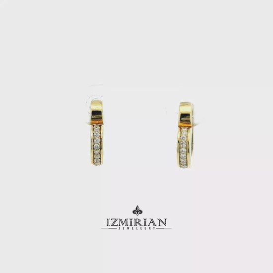 White enamel diamond heart hoop earrings in yellow gold shown in motion