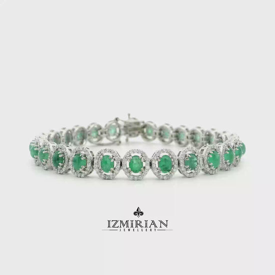 Emerald and diamond halo tennis bracelet in white gold shown in motion