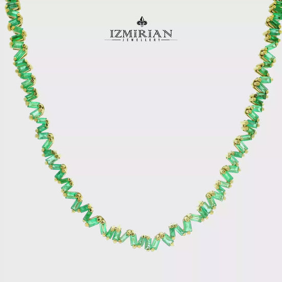 Zigzag emerald baguette necklace in yellow gold shown in motion