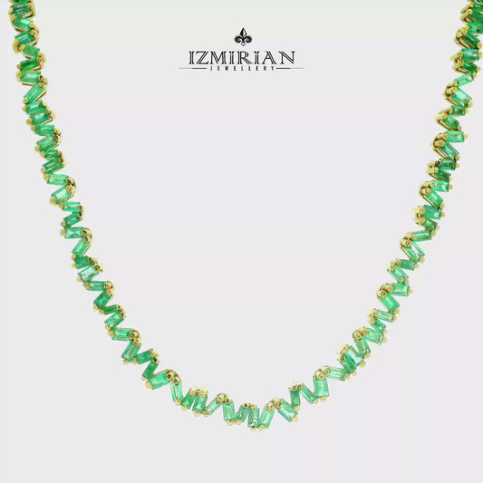 Zigzag emerald baguette necklace in yellow gold shown in motion