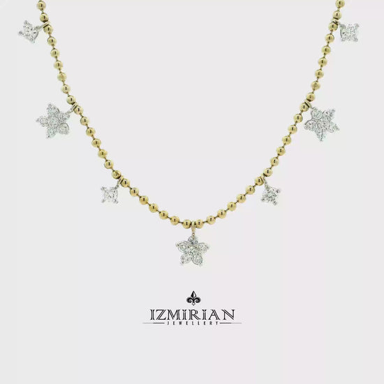 Diamond star charm necklace in yellow gold shown in motion