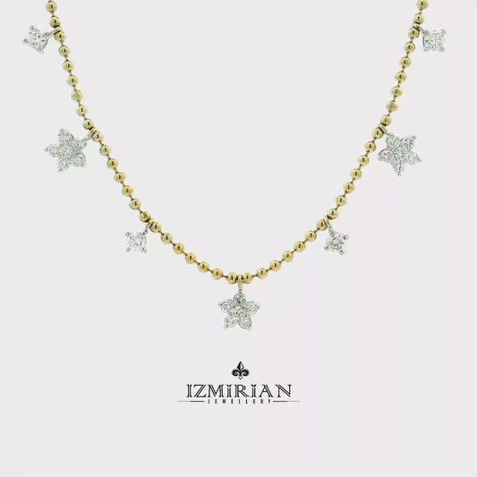 Diamond star charm necklace in yellow gold shown in motion