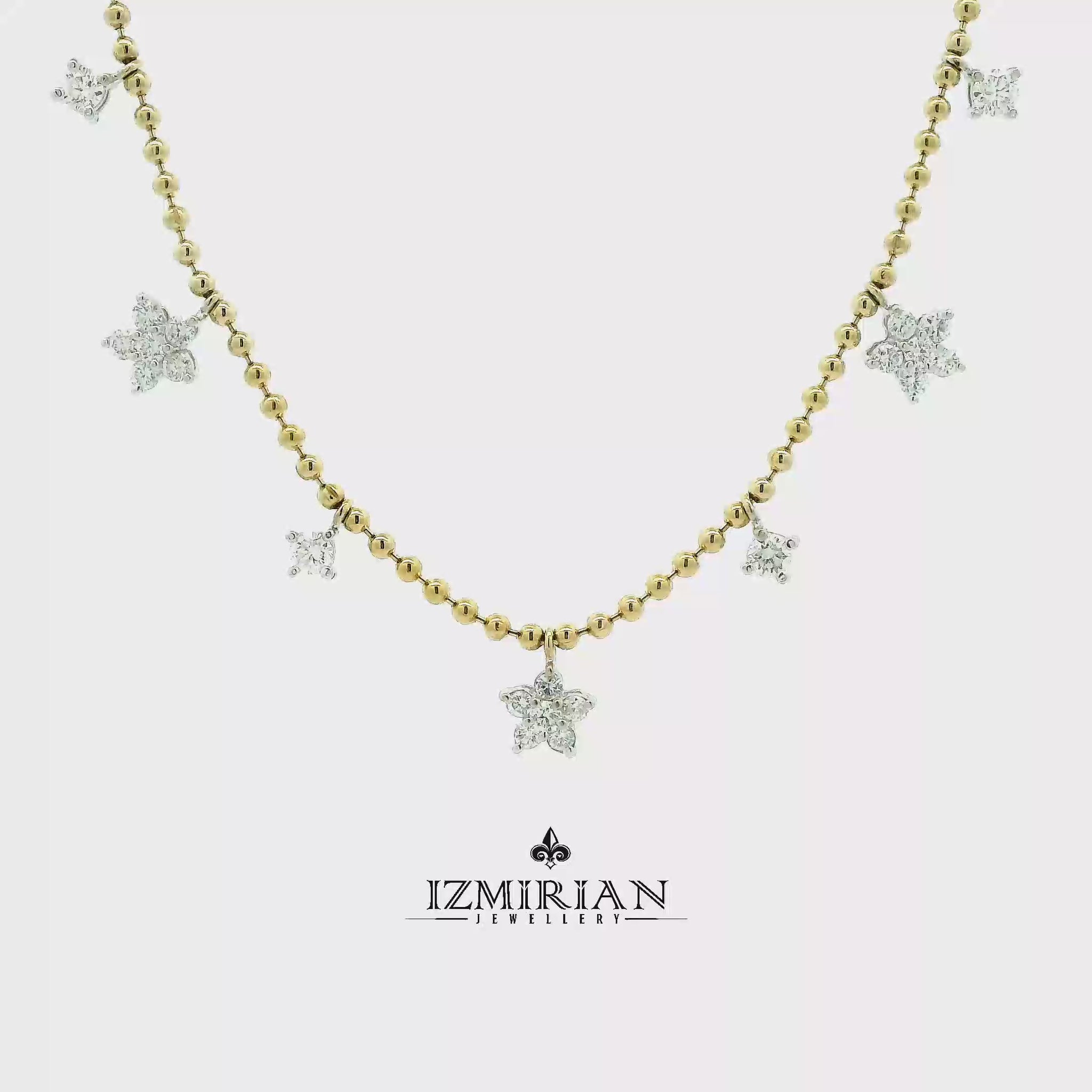 Diamond star charm necklace in yellow gold shown in motion