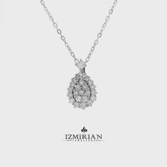 Diamond teardrop cluster pendant in white gold shown in motion