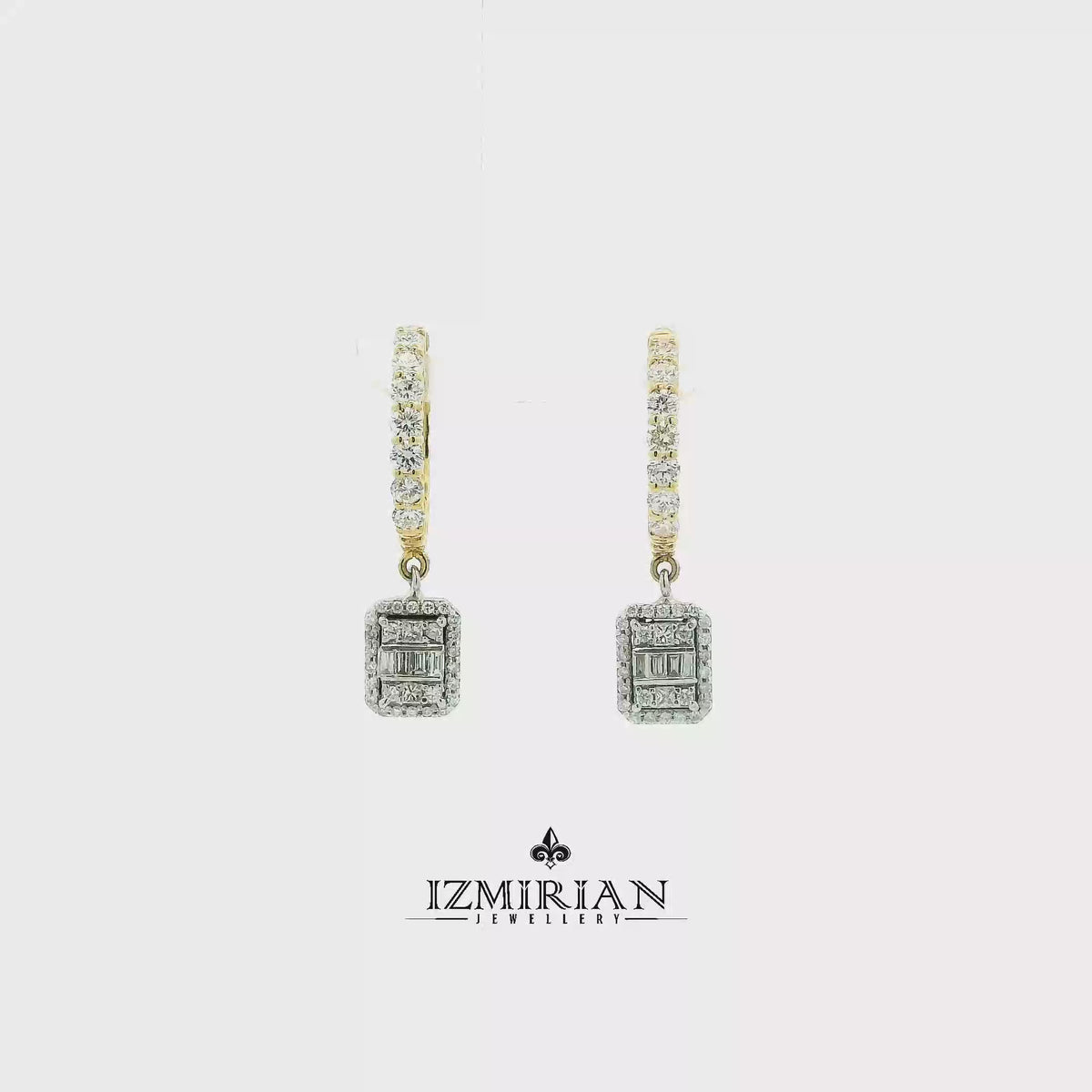 Baguette diamond drop hoop earrings in yellow and white gold shown in motion