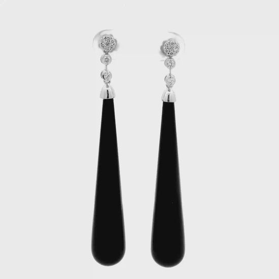 Black onyx diamond drop earrings in white gold shown in motion
