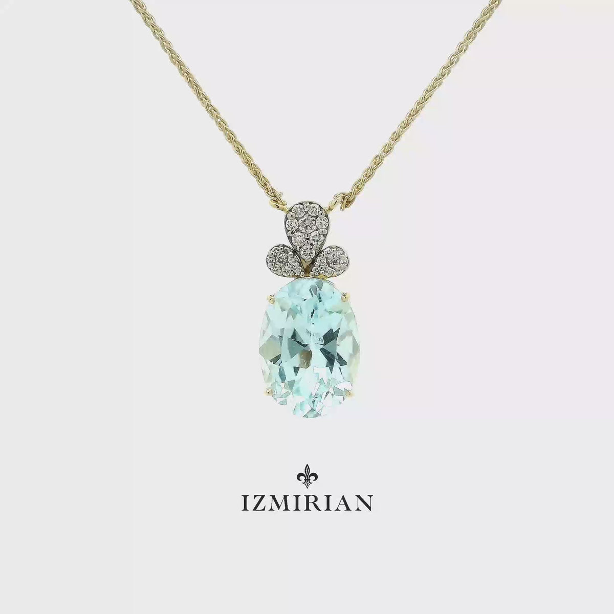Aquamarine diamond drop pendant necklace in yellow gold shown in motion
