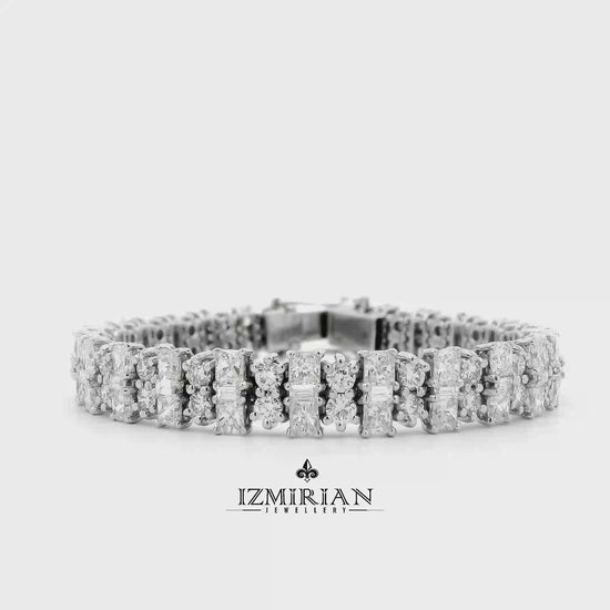 Alternating cut diamond tennis bracelet in white gold shown in motion