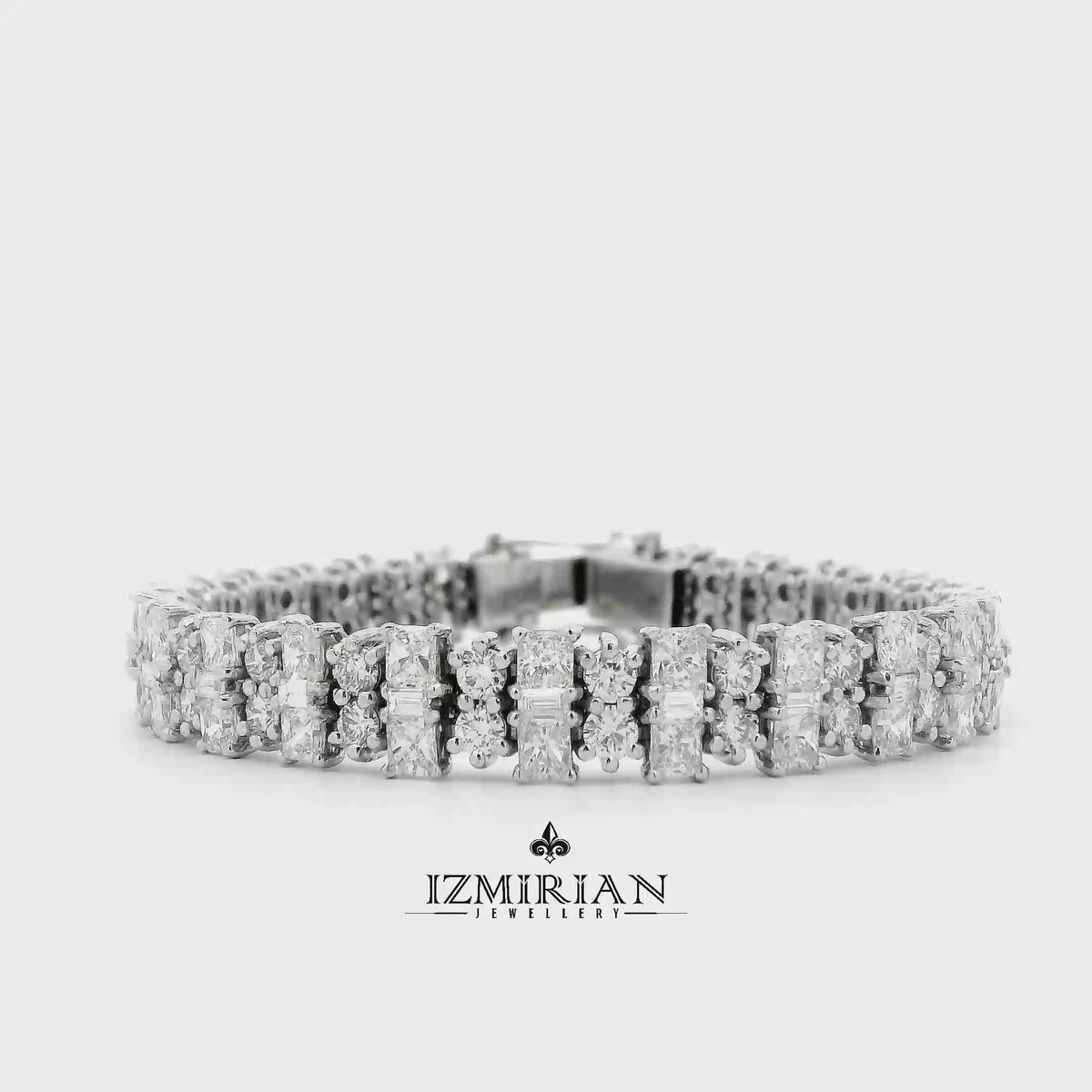 Alternating cut diamond tennis bracelet in white gold shown in motion
