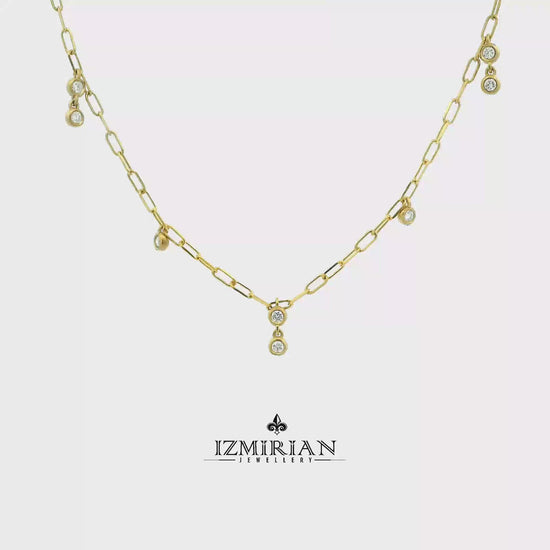 Bezel set diamond drop necklace in yellow gold shown in motion