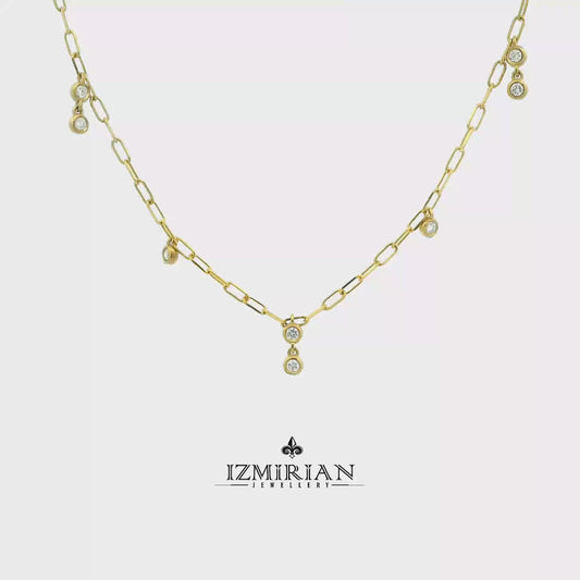 Bezel set diamond drop necklace in yellow gold shown in motion