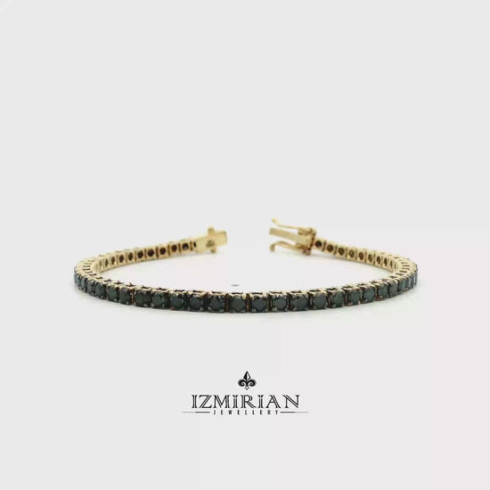 Black diamond tennis bracelet in yellow gold shown in motion