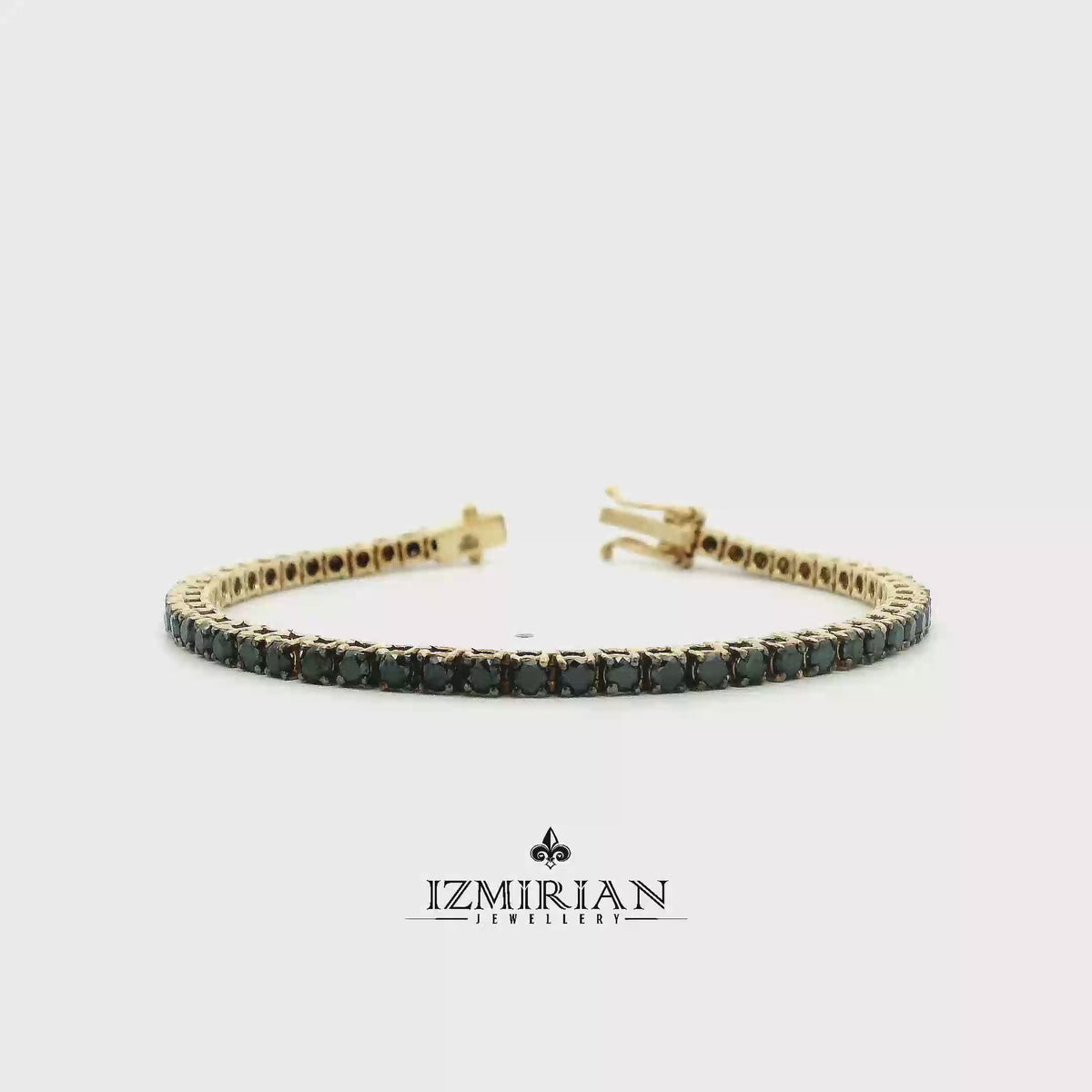 Black diamond tennis bracelet in yellow gold shown in motion