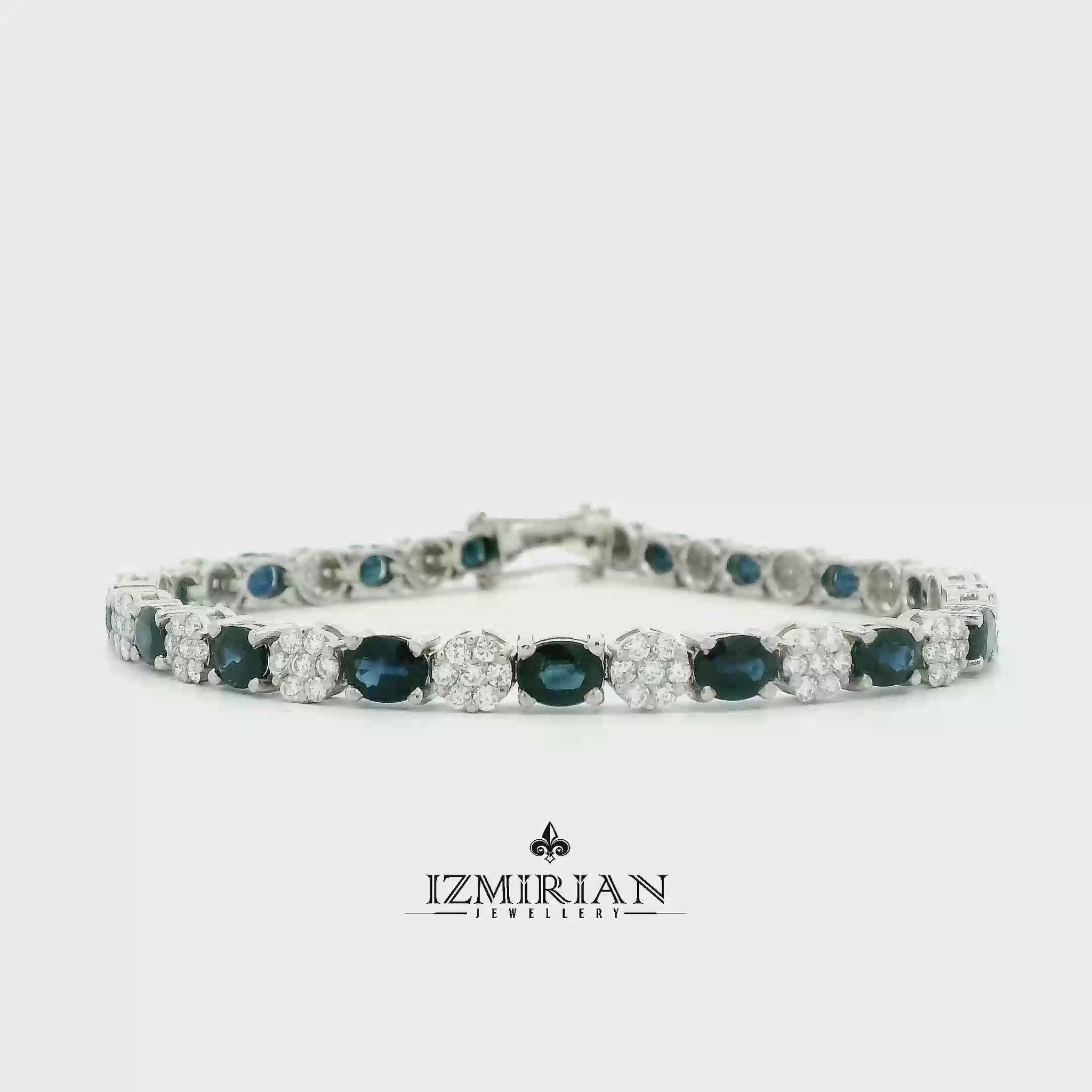 Blue sapphire and diamond tennis bracelet in white gold shown in motion