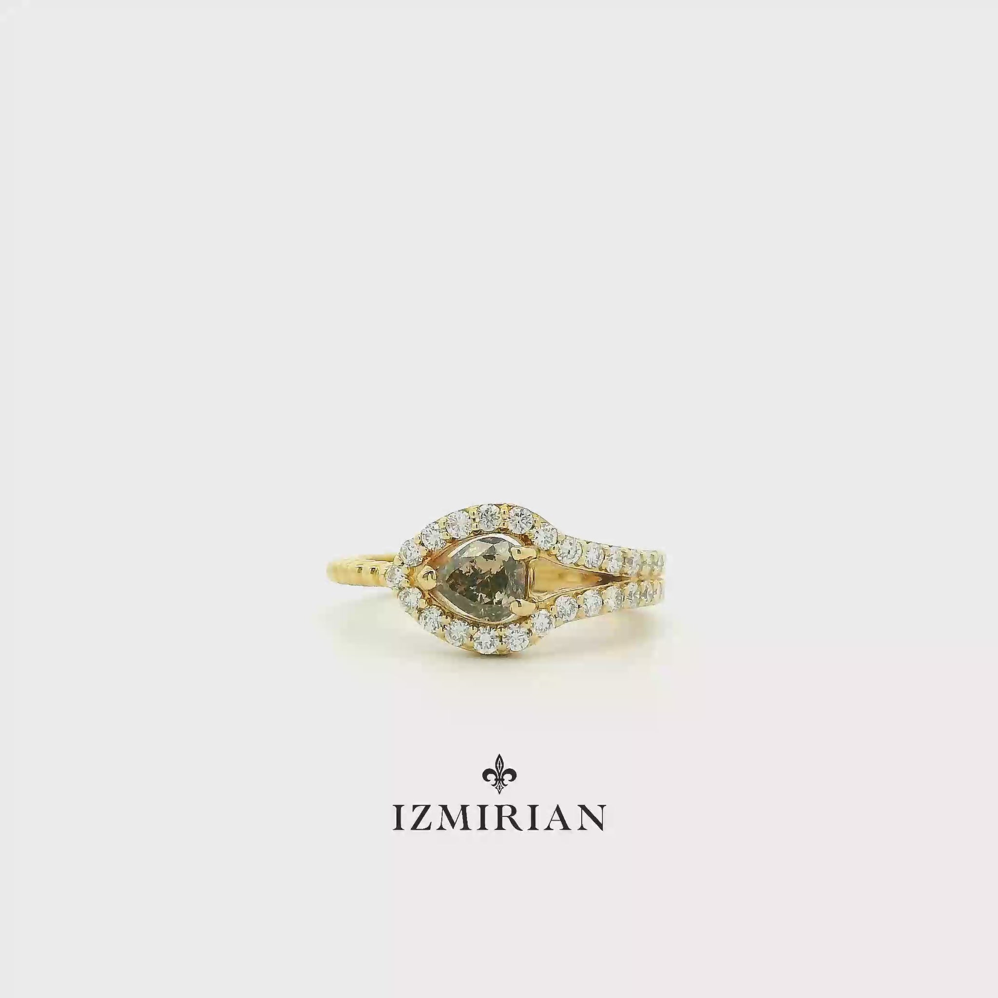 Pear-cut diamond halo ring in yellow gold shown in motion