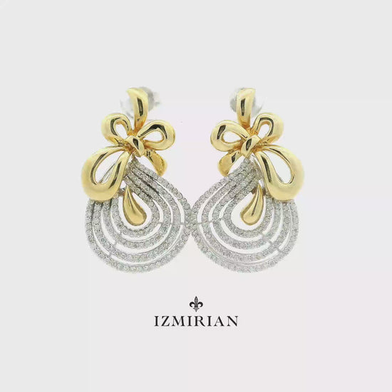 Diamond bow drop earrings in yellow and white gold shown in motion