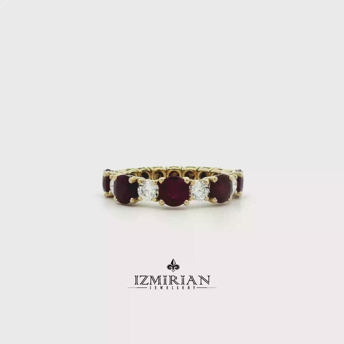 Ruby and diamond eternity band in yellow gold shown in motion