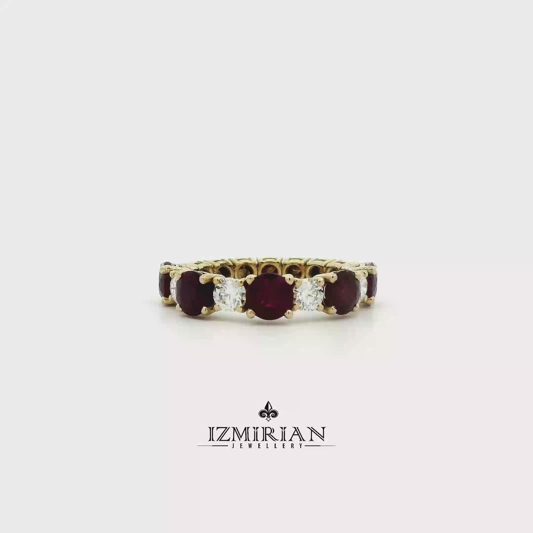 Ruby and diamond eternity band in yellow gold shown in motion