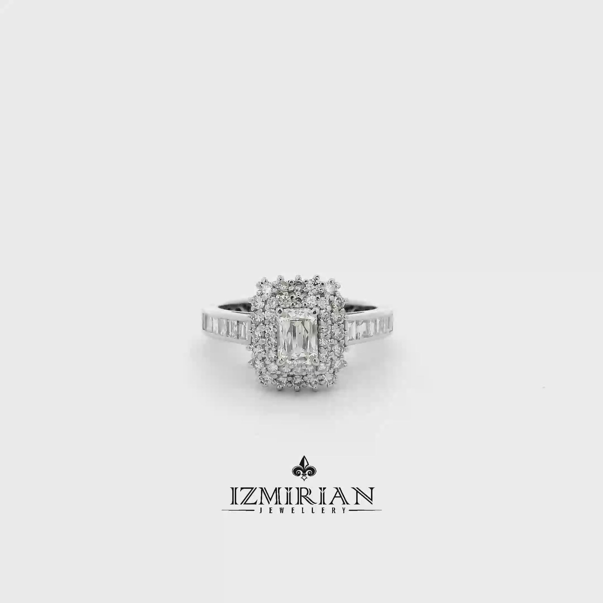 Emerald cut diamond halo ring in white gold shown in motion