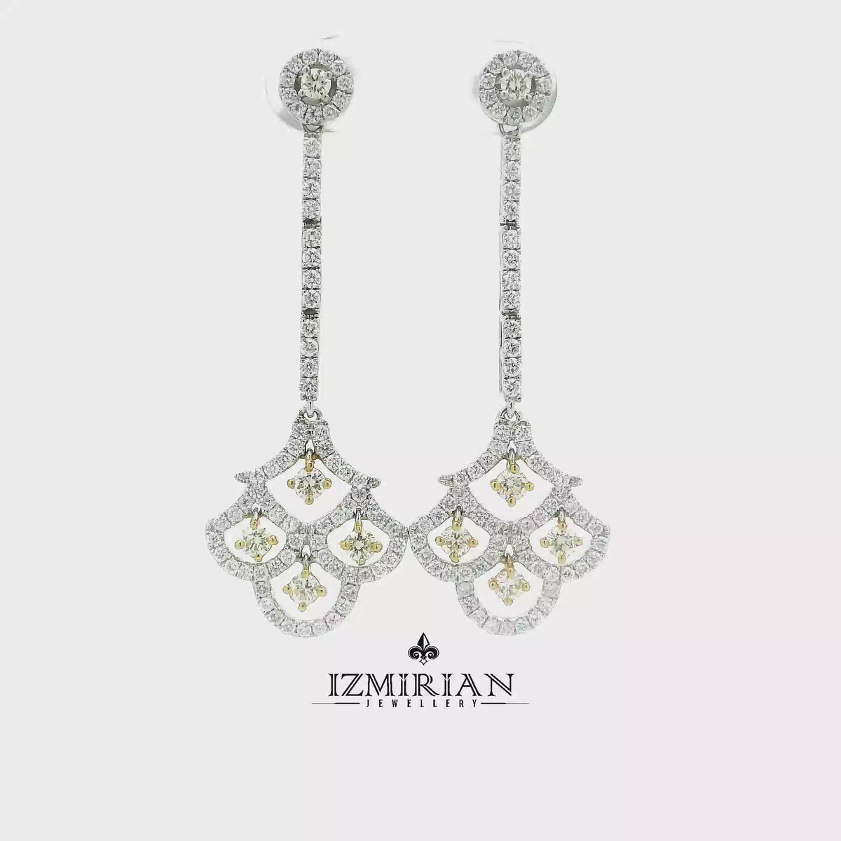 Diamond fan drop earrings in yellow and white gold shown in motion