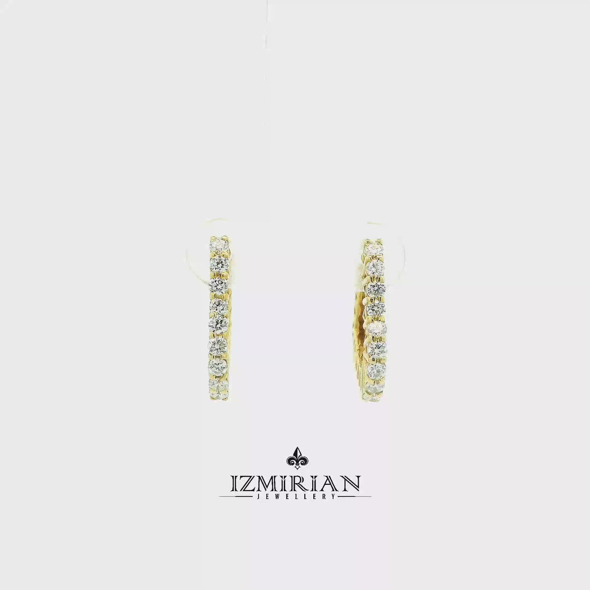 Inside out diamond hoop earrings in yellow gold shown in motion