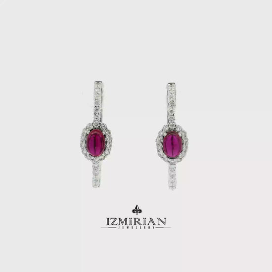 Ruby halo drop earrings in white gold shown in motion