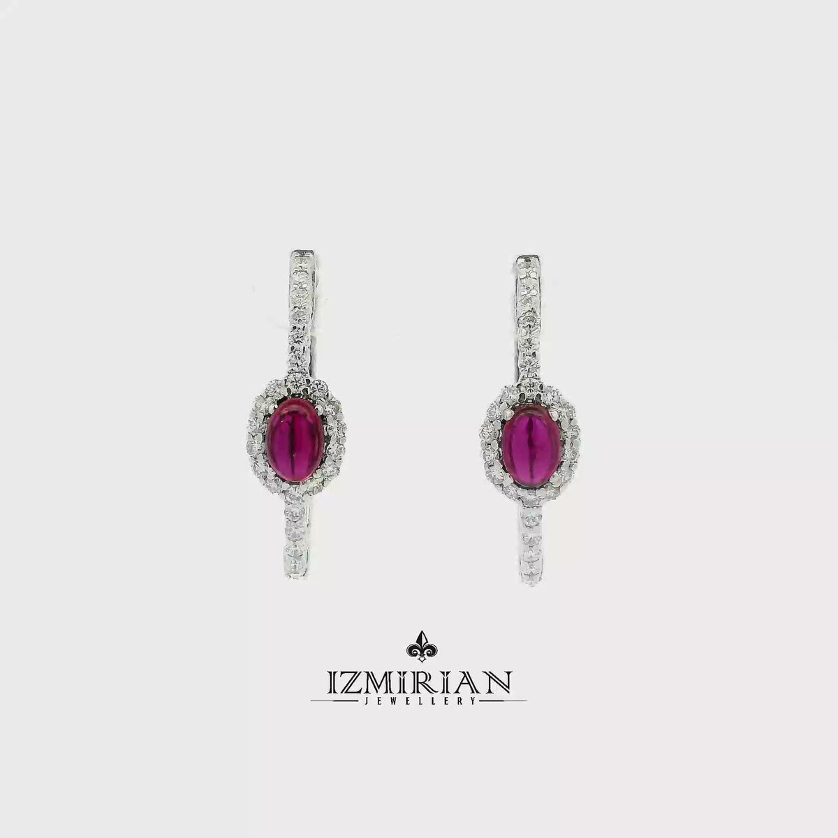 Ruby halo drop earrings in white gold shown in motion