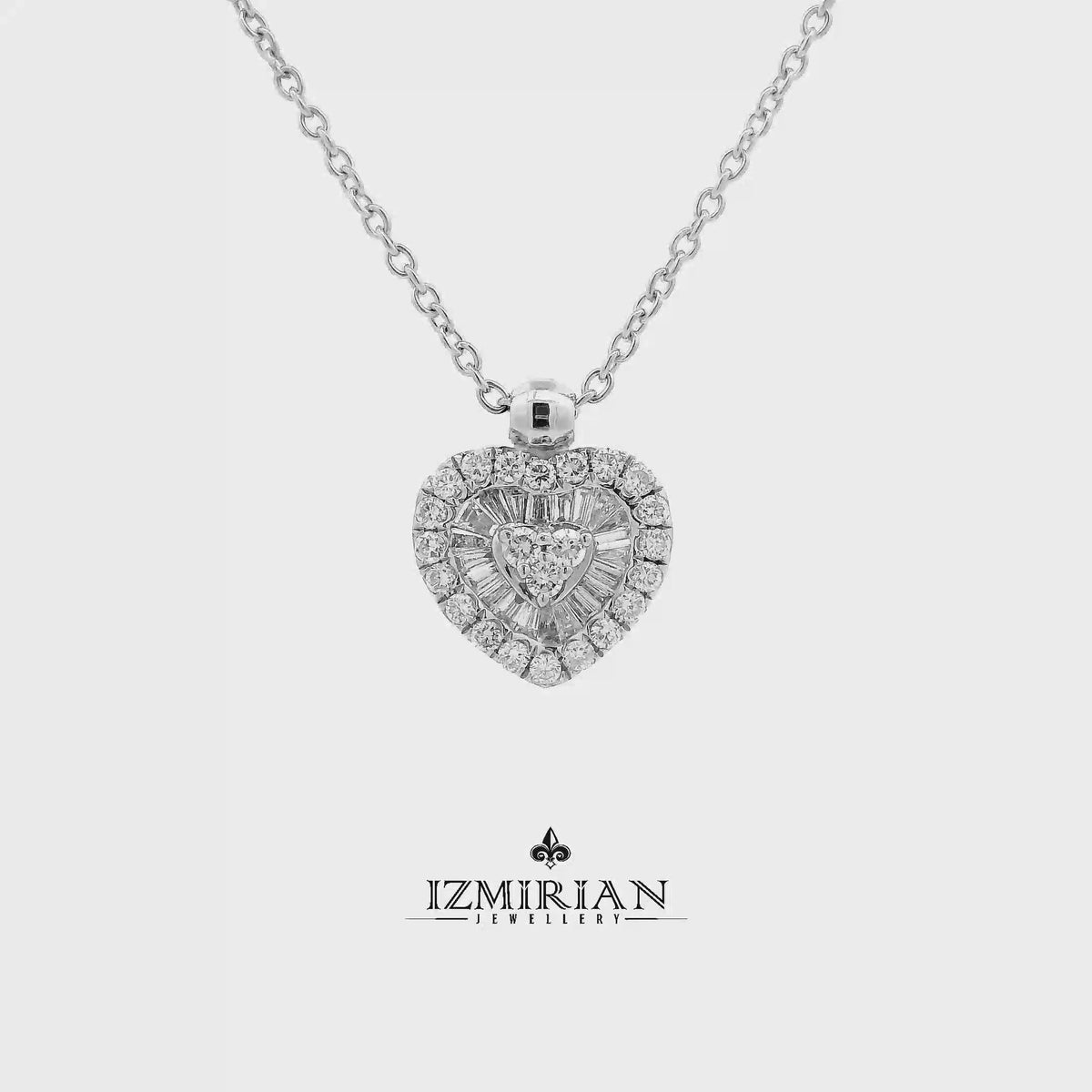 Heart diamond cluster pendant in white gold shown in motion