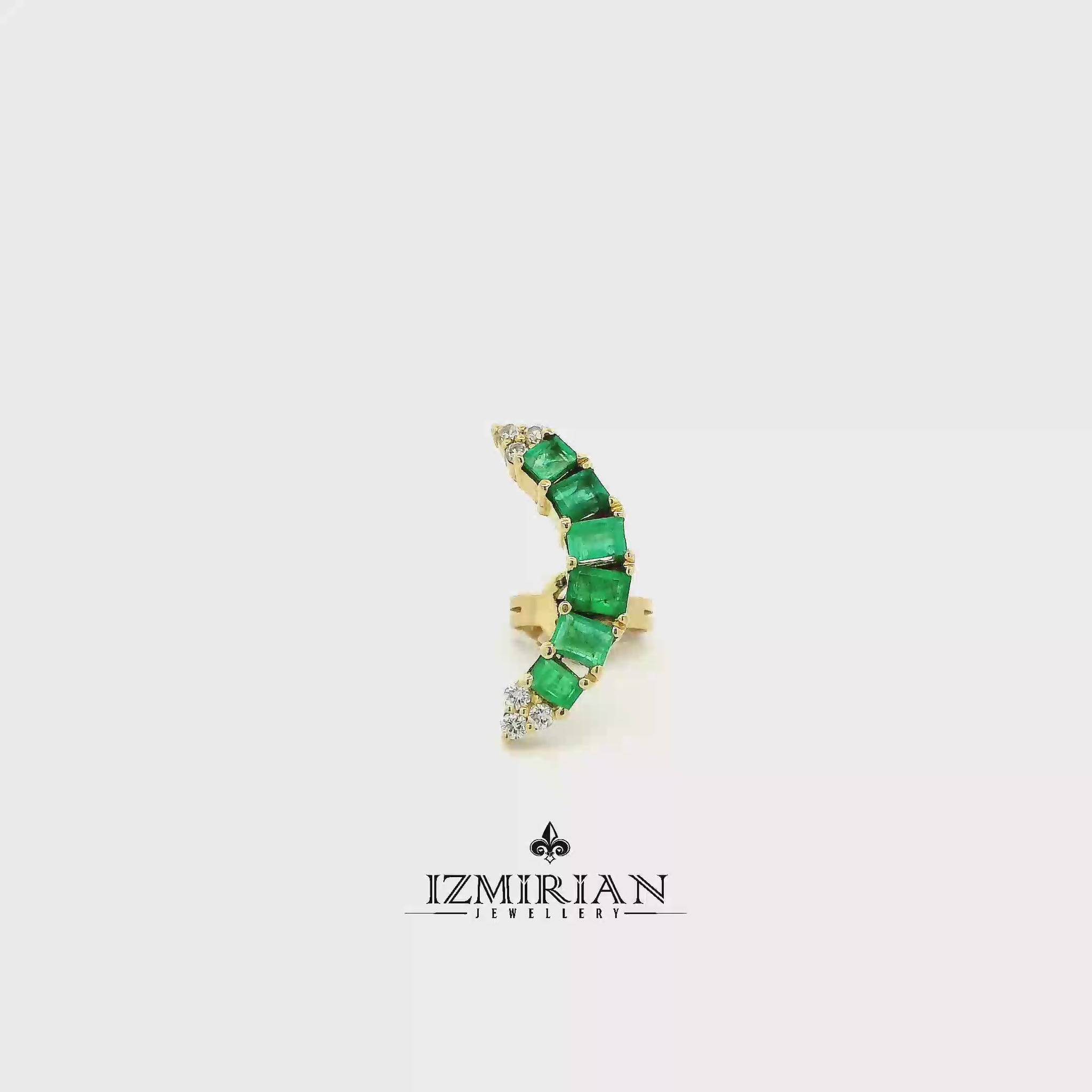 Emerald curve ring in yellow gold shown in motion