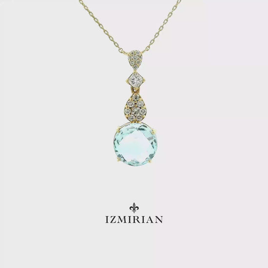 Aquamarine and diamond drop pendant necklace in yellow gold shown in motion