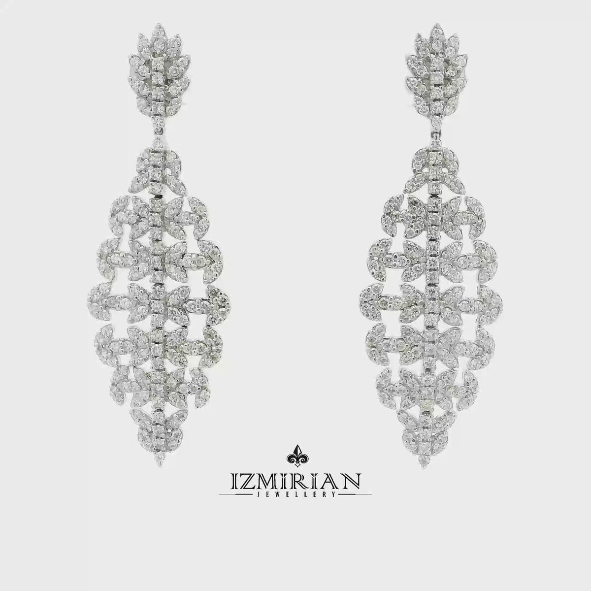 Diamond cascade drop earrings in white gold shown in motion