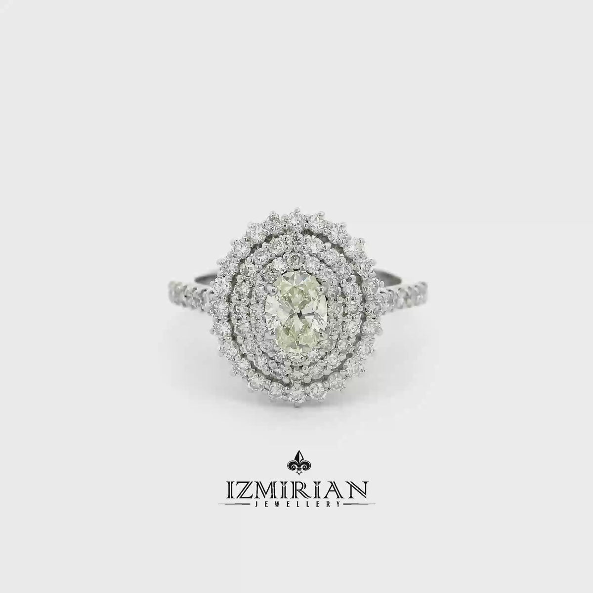Oval diamond triple halo ring in white gold shown in motion