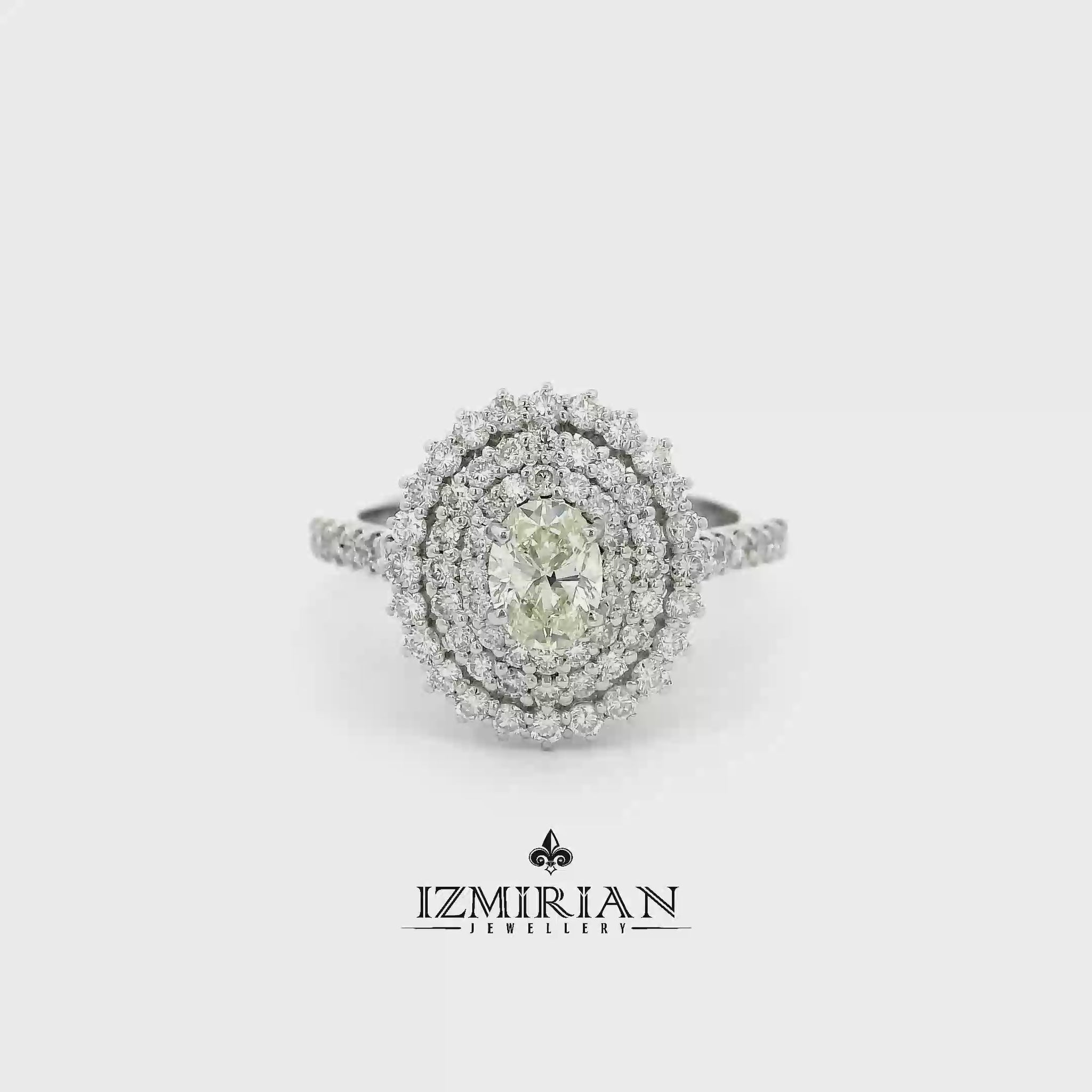 Oval diamond triple halo ring in white gold shown in motion