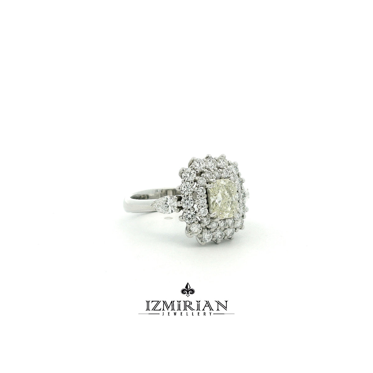 Side view of white gold ring with radiant diamond and multi layer halo